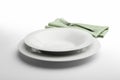 Empty round white plate and bowl with napkin and fork Royalty Free Stock Photo
