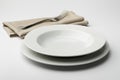 Empty round white plate and bowl with napkin and fork Royalty Free Stock Photo