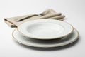 Empty round white plate and bowl with napkin and fork Royalty Free Stock Photo