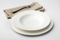 Empty round white plate and bowl with napkin and fork Royalty Free Stock Photo