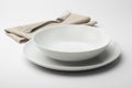 Empty round white plate and bowl with napkin and fork Royalty Free Stock Photo