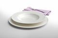Empty round white plate and bowl with napkin and fork Royalty Free Stock Photo