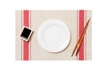 Empty round white plate with chopsticks for sushi and soy sauce on sushi mat background. Top view with copy space for you design Royalty Free Stock Photo