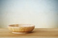 Empty round wooden plate on wood table background, food display