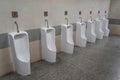 Empty row of outdoor urinals men public toilet. White ceramic urinals for man in toilet room. Gentlemen restroom in the restaurant Royalty Free Stock Photo