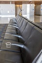 An empty row of seats at an airport waiting for passengers Royalty Free Stock Photo