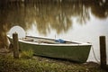 Empty rowboat on lake Chiemsee in autumn Royalty Free Stock Photo