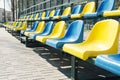 Empty rows of blue and yellow seats on the school sport court, outdoor Royalty Free Stock Photo