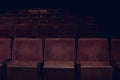 Empty rows of red vintage seats in movie theater