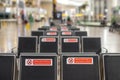 Empty rows of seats in the airport lounge during the coronavirus pandemic. Close-up warning inscription keep distance, do not Royalty Free Stock Photo