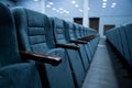 Empty rows of seats in the hall for a large number of people. Cinema and theatre hall for watching performances. Royalty Free Stock Photo