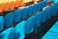 Empty rows of seats in the stadium. Blue and yellow chairs, nobody present at a sport show simple abstract concept Royalty Free Stock Photo
