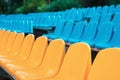 Empty rows of seats in the stadium. Blue and yellow chairs, nobody present at a sport show simple abstract concept Royalty Free Stock Photo