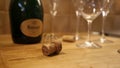 Empty Ruinart Champagne Bottle, Cork and Empty Champagne Glasses on a Table