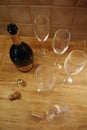 Empty Ruinart Champagne Bottle, Cork and Empty Champagne Glasses on a Table