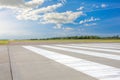 Empty Runway, airstrip in the airport with marking on blue sky with clouds background. Travel aviation concept