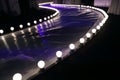 Empty Runway Fashion Show with Ball glowing lighting along walk way Royalty Free Stock Photo