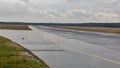 Empty runway at the passenger airport in the rain