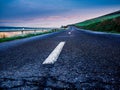 Empty rural asphalt road on a cold spring early morning Royalty Free Stock Photo