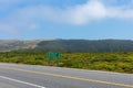 Empty rural two lane asphalt highway with distance sign Royalty Free Stock Photo