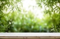 Empty rustic old wooden boards table copy space with bamboo plants forest in background. Product display template. Generative AI Royalty Free Stock Photo