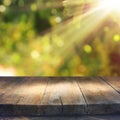 Empty rustic table in front of green spring abstract bokeh background. product display and picnic concept. Royalty Free Stock Photo