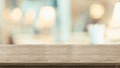 Empty rustic wood table and blurred soft light table in restaurant with bokeh background. product display