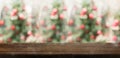 Empty rustic wood table top with abstract blur christmas tree re