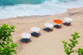 Empty sand beach background with bright tent, recliners and surf waves, view from above Royalty Free Stock Photo