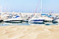 Empty sand beach in front of pier with boats and summer sea background. copy space Royalty Free Stock Photo