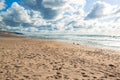 Empty sand beach, stormy Pacific Ocean, and beautiful cloudy sky. Royalty Free Stock Photo