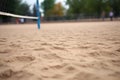 empty sand volleyball court, net in sharp focus