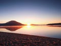 Empty sandy beach in island in romantic colors of tropical sunset. The foot steps in sand. Royalty Free Stock Photo