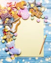 Empty Santa letter with Christmas traditional ginger cookies around it on wooden background. Christmas or New Year holiday