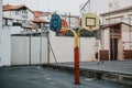 Empty school asphalt playground in the backyard with three color baskets for basketball and part for handball in background Royalty Free Stock Photo