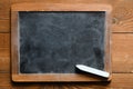 Empty school chalk board on a wooden table. Empty space to enter text or insert graphics. Concept in education or business Royalty Free Stock Photo
