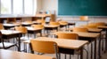 Empty school classroom with desks and chairs set for use. The light and shadows create a welcoming back to school scene Royalty Free Stock Photo