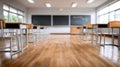 Empty school classroom with desks and chairs set for use. The light and shadows create a welcoming back to school scene Royalty Free Stock Photo