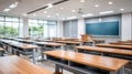 Empty school classroom with desks and chairs set for use. The light and shadows create a welcoming back to school scene Royalty Free Stock Photo