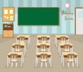 Empty school classroom with green chalkboard