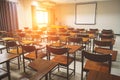 Empty school classroom with many wooden chairs Royalty Free Stock Photo
