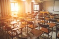 Empty school classroom with many wooden chairs