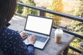 Empty Screen laptop Blogger Woman hands typing computer keyboard. Close up women hands using laptop sitting at coffee shop garden Royalty Free Stock Photo