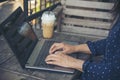 Empty Screen laptop Blogger Woman hands typing computer keyboard. Close up women hands using laptop sitting at coffee shop garden Royalty Free Stock Photo