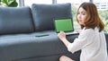 Empty Screen laptop Blogger Woman hands typing computer keyboard. Close up women hands using laptop sitting at sofa in living room Royalty Free Stock Photo