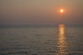 Empty sea to the horizon, evening. The sun is approaching the horizon, a light path is visible on the water Royalty Free Stock Photo