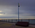 Empty seafront after the announcement of an impending storm. Raised warning sign - black ball. Royalty Free Stock Photo