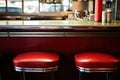 an empty seat at a counter from 1960s diner