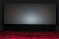 Empty seat on row in thearter with movie screen
