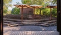 Empty seats audience area outdoor theater long wooden benches city park umbrella Royalty Free Stock Photo